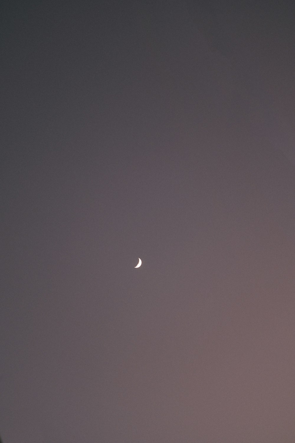 a crescent moon in a dark sky