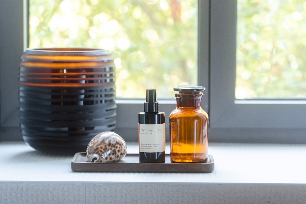 a window with a bowl of food and a bottle of liquid