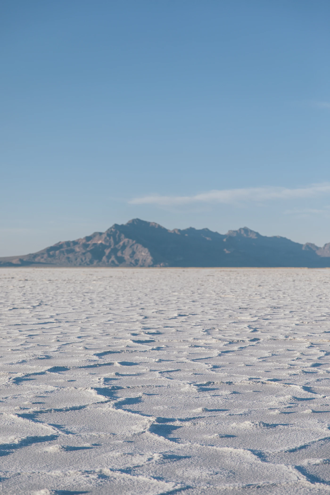 A mountain range rising from the white salt flats of western Utah