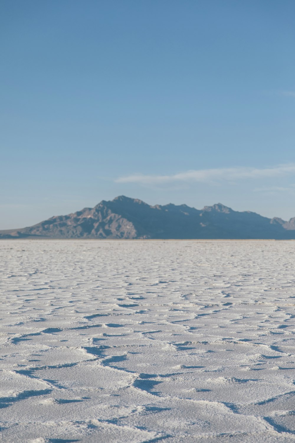 a body of water with mountains in the background