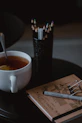 A calm, minimalist workspace with a notebook, pen, and a warm cup of tea, symbolizing personal coaching sessions.