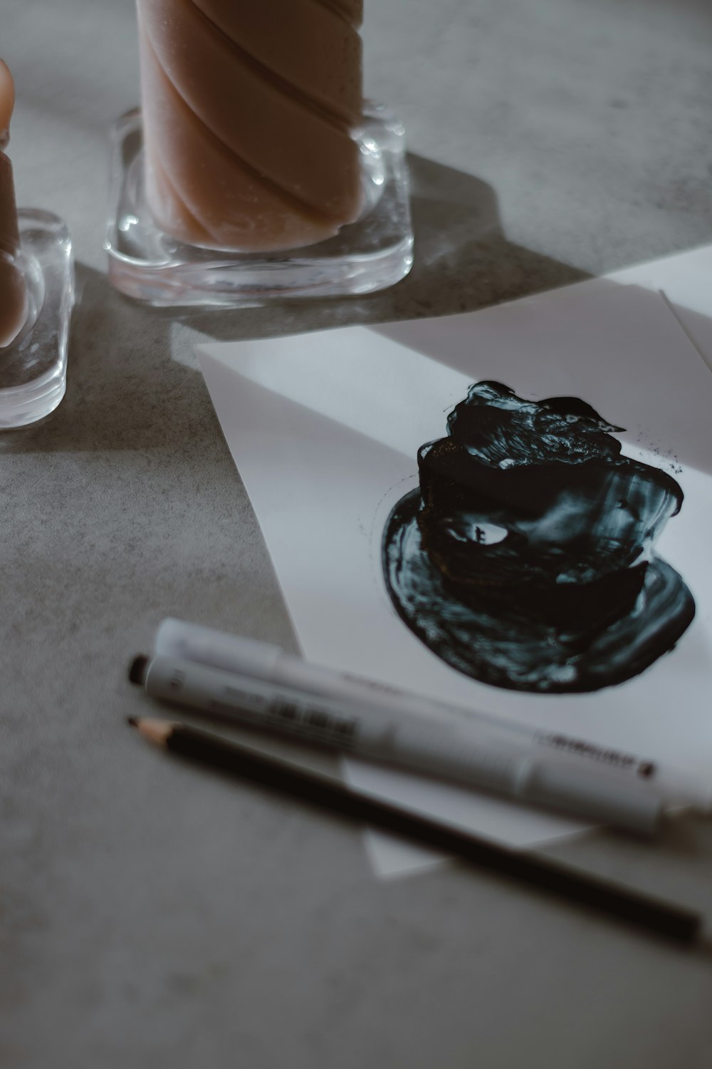 a black rock on a white surface