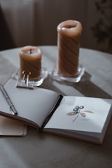 A cozy scene of the launch party setup with candles, the oracle deck, and art book displayed on a black table.