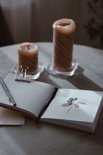 A cozy scene of the launch party setup with candles, the oracle deck, and art book displayed on a black table.