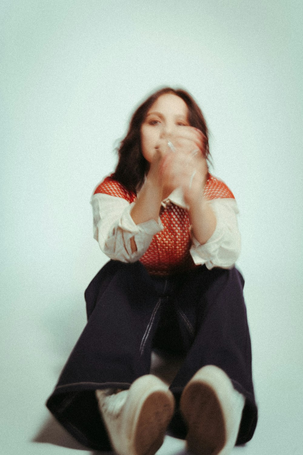 a person sitting on a chair smoking a cigarette