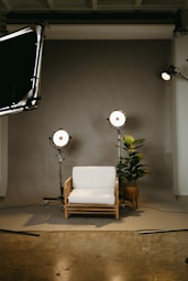 a white chair and a lamp in a room