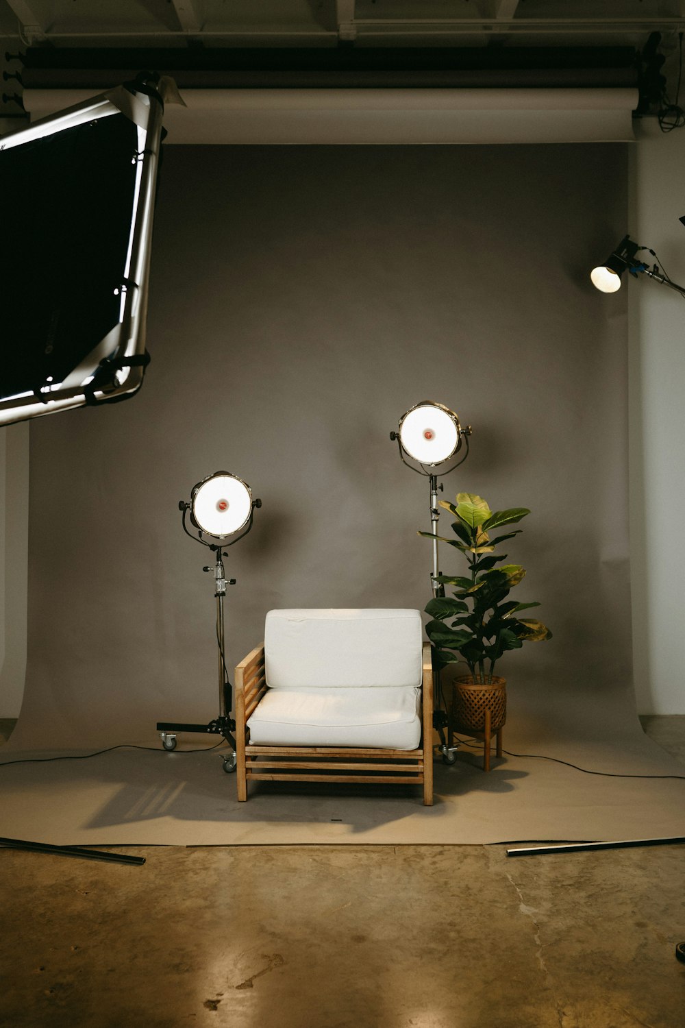 a white chair and a lamp in a room