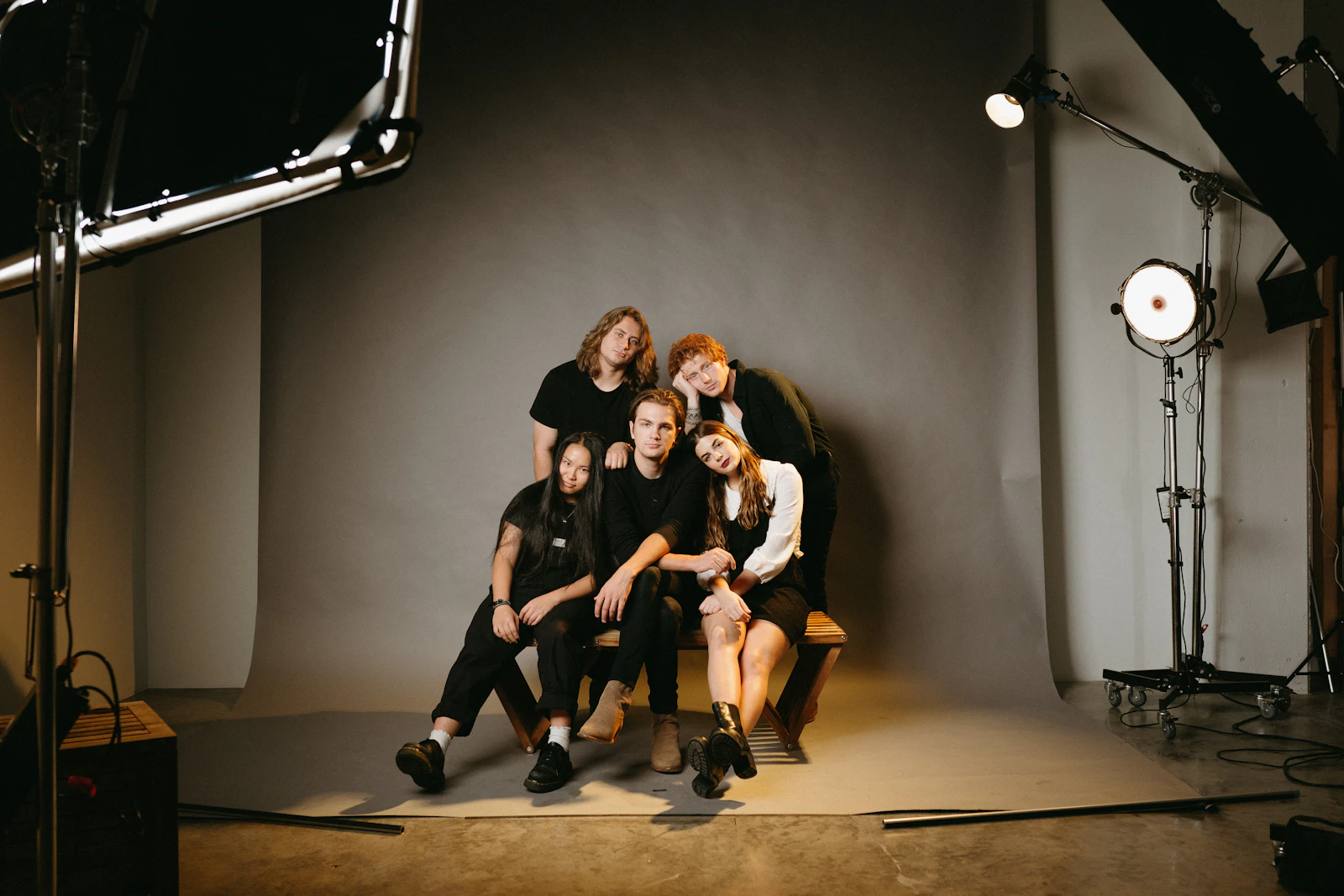 Crew gathered on a studio set with lighting stands