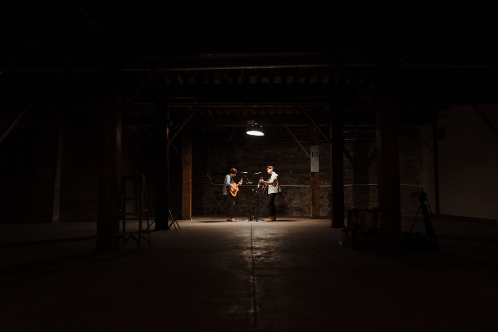 a group of people standing in a dark room