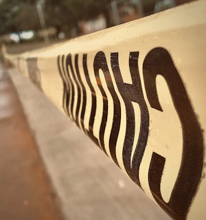 Close-up of a red warning tape with crime scene markers in bold black and yellow colors.