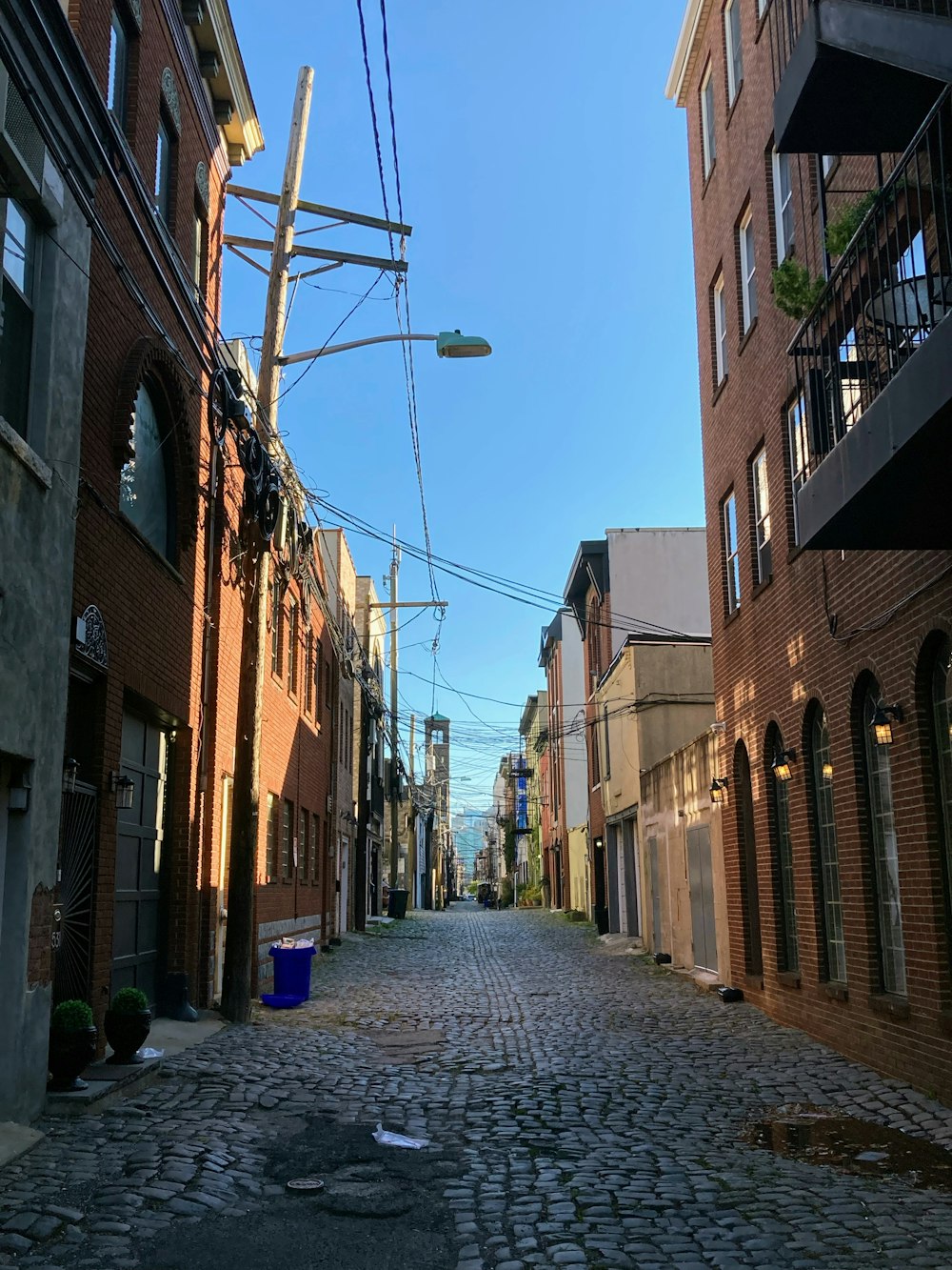 a cobblestone street between buildings