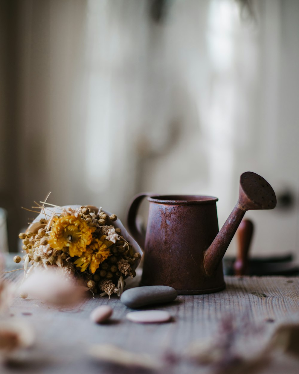 a vase and a flower on a table