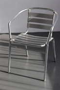 Image of metal furniture including chairs and tables with clean lines.