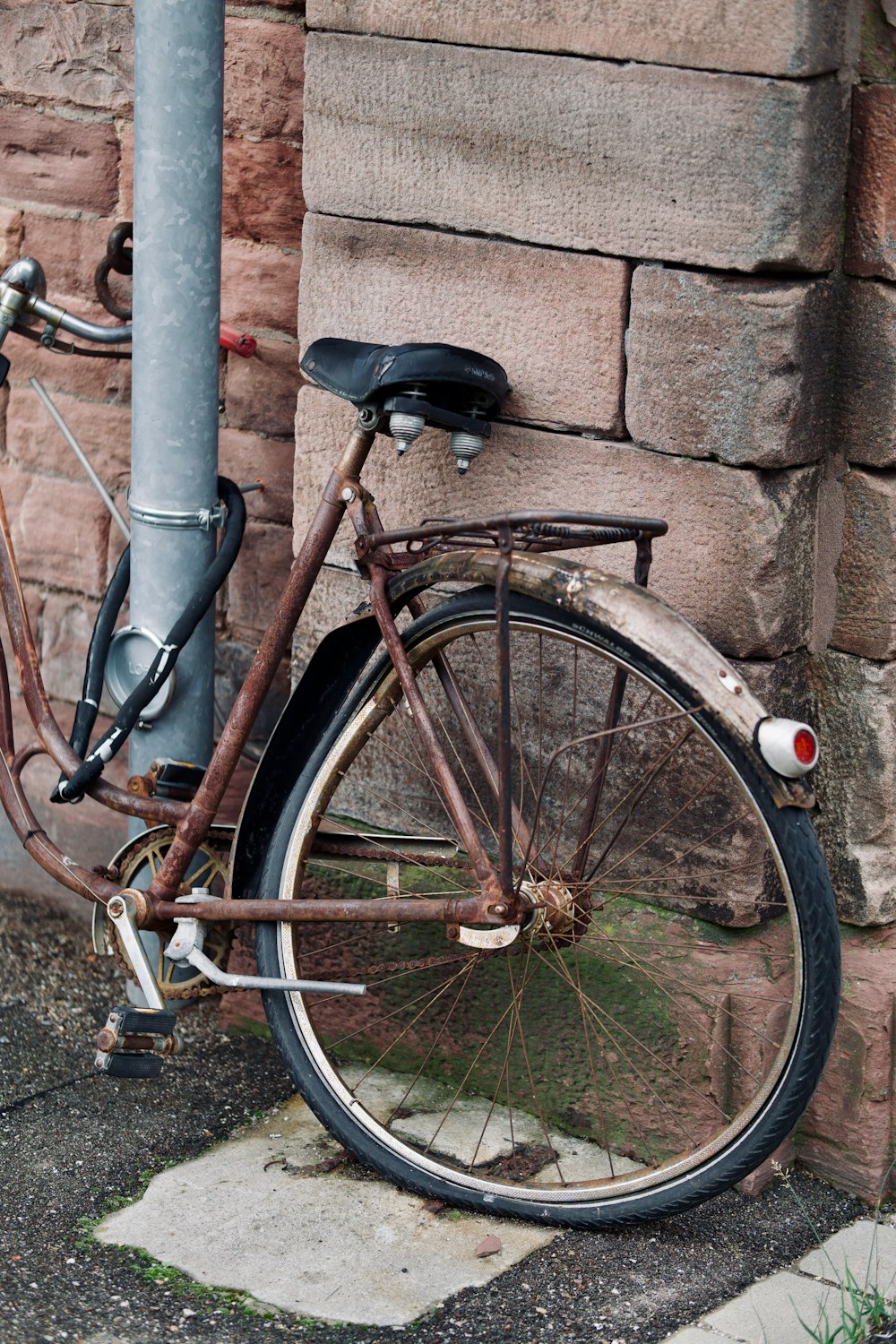 a bicycle parked against a wall