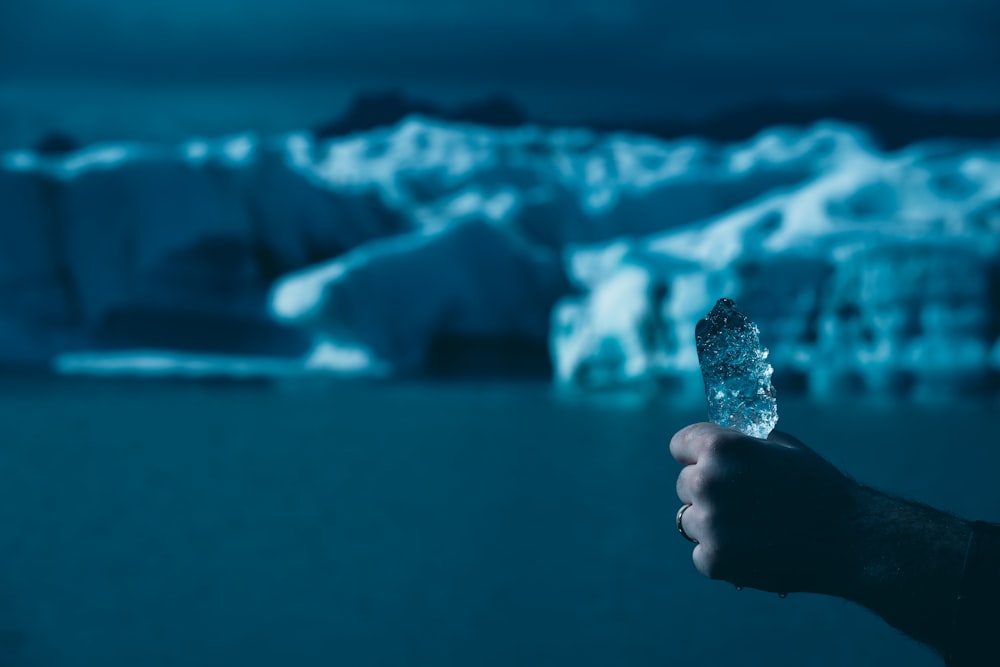 a hand holding a bottle of water