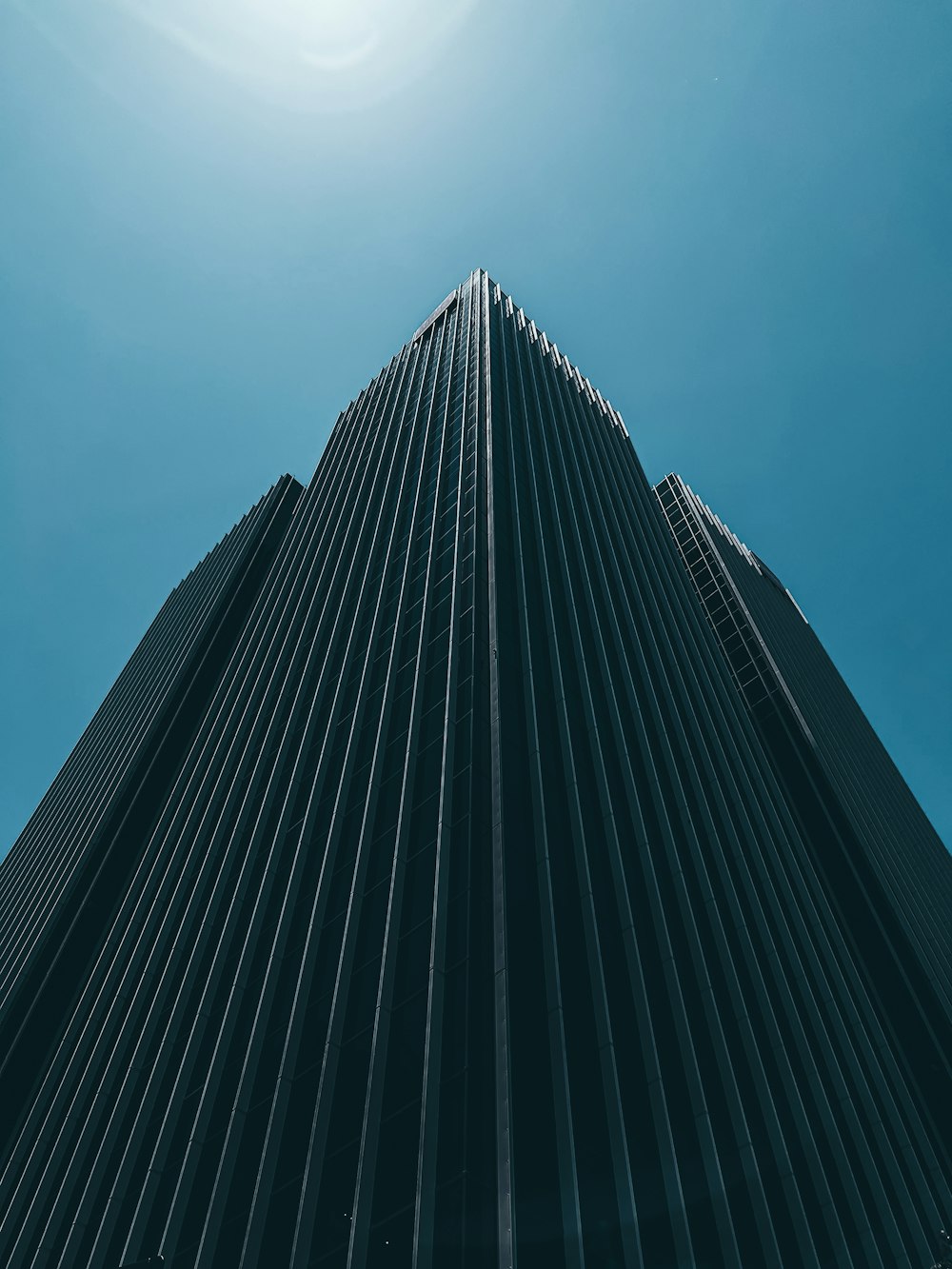 a tall building with a blue sky