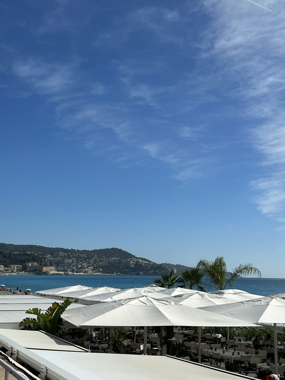 a large white tent next to a body of water