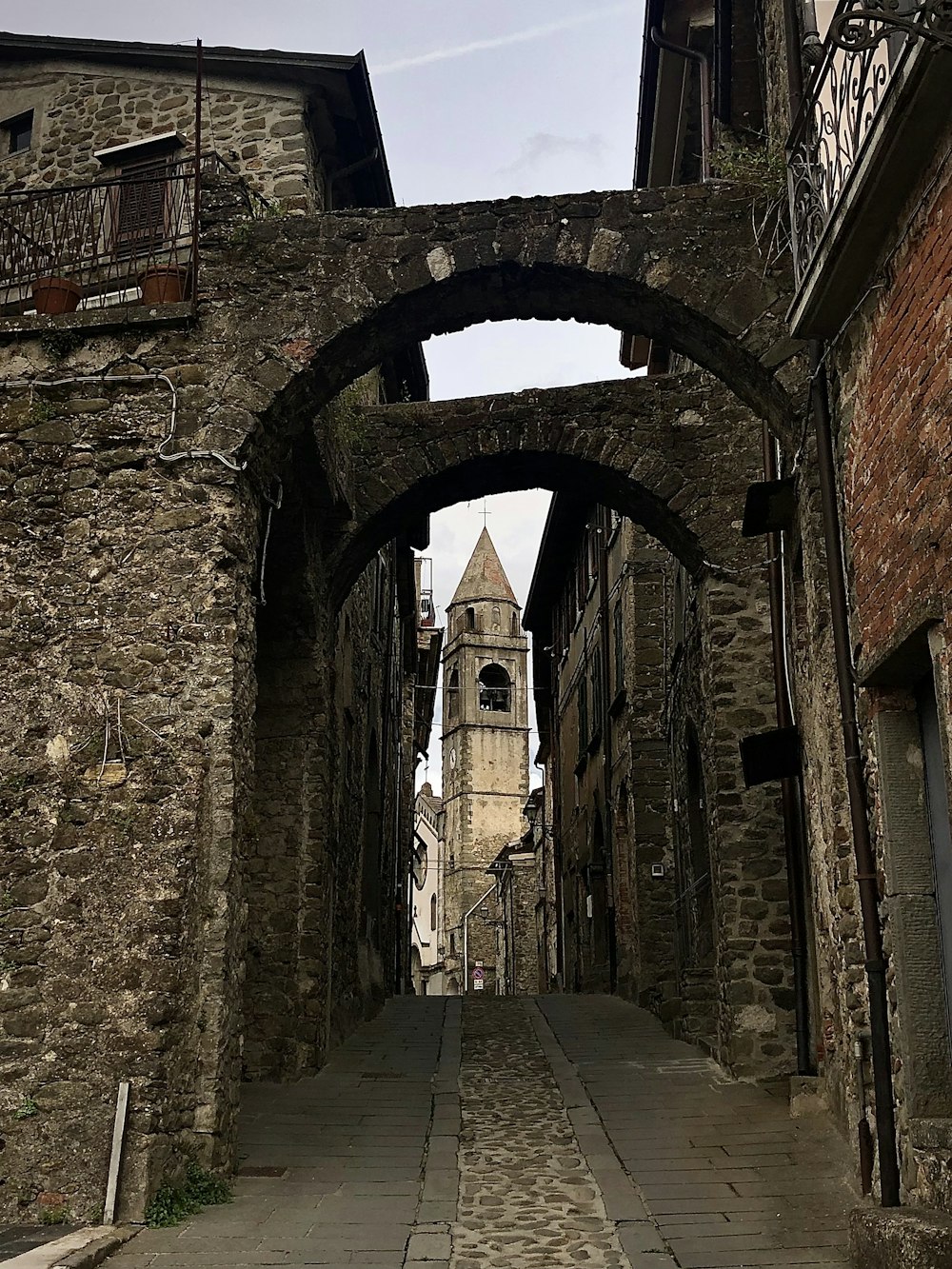 a stone walkway between two buildings