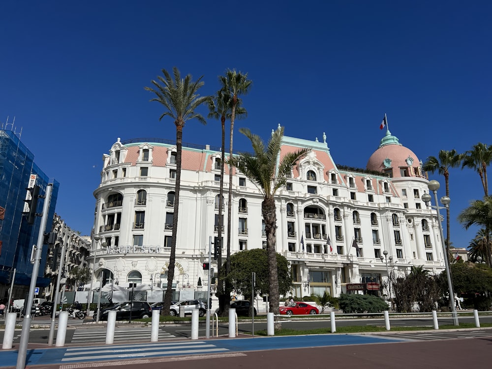 a white building with palm trees