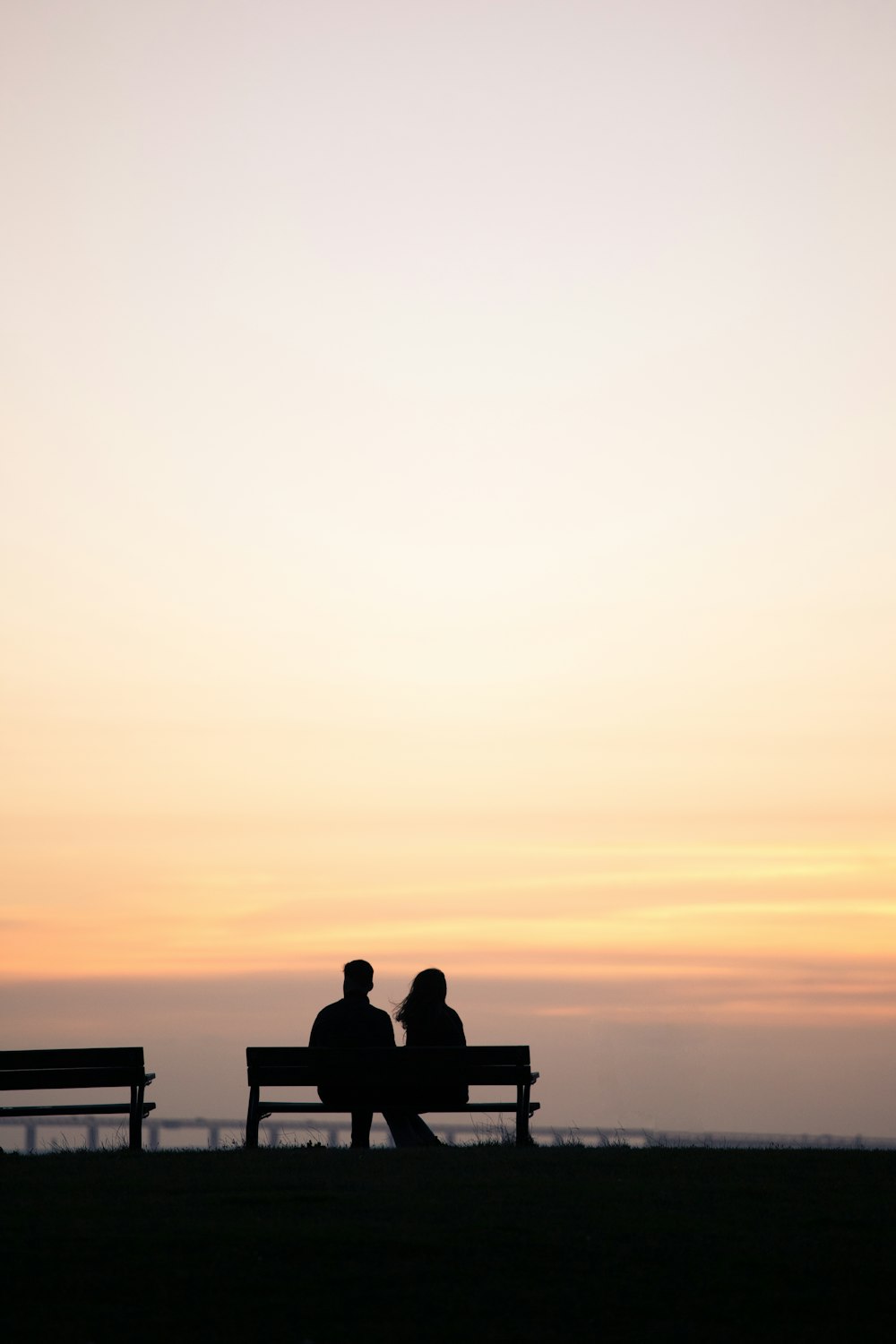 a couple sitting on a bench