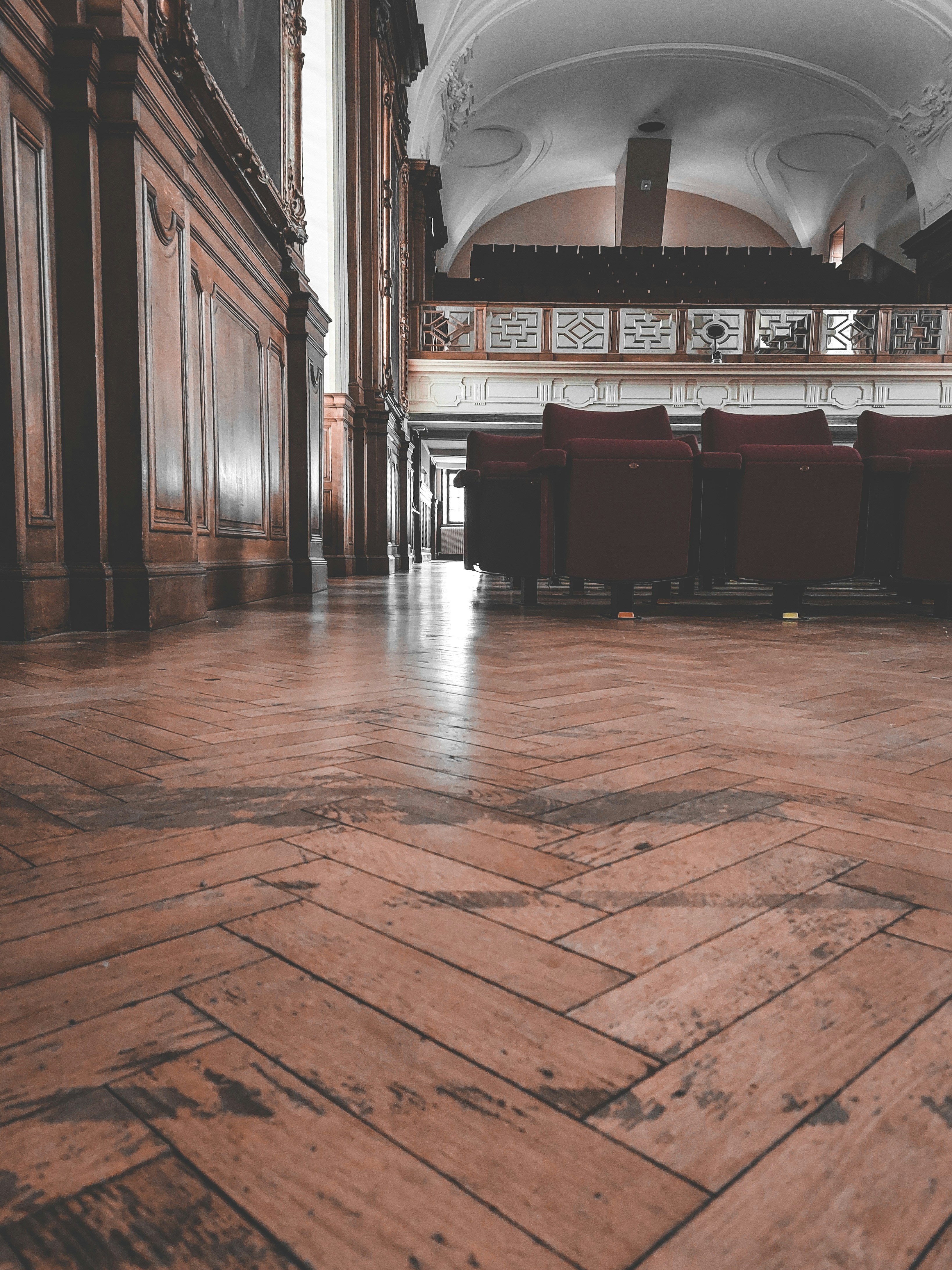 a room with a wood floor and chairs