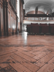 a room with a wood floor and chairs