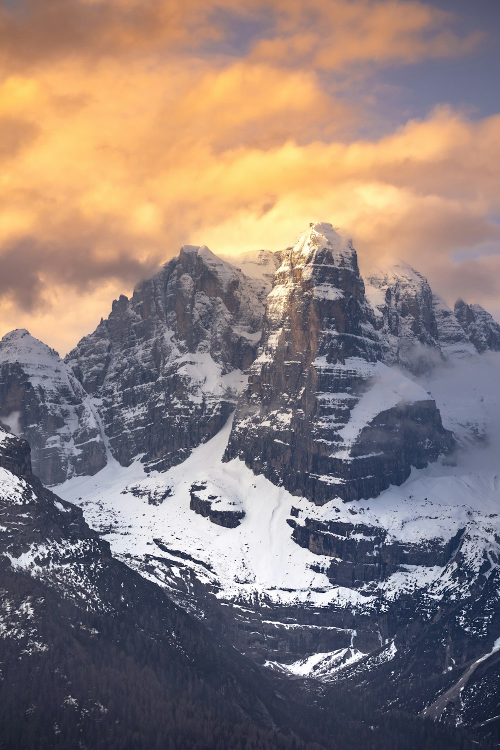 a snowy mountain with a cloudy sky