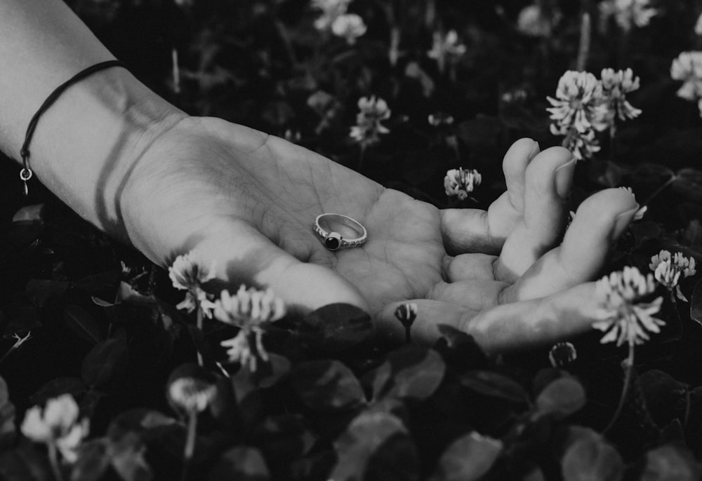 a pair of hands holding a ring