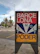 Photo of a sleek, custom-designed signboard installed outside a modern shop.