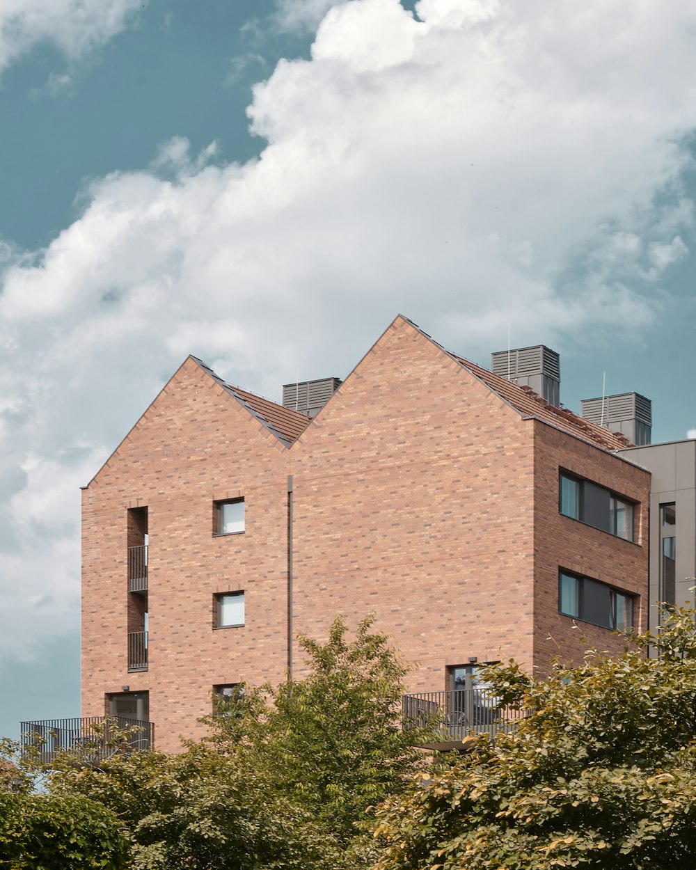 a brick building with trees in front of it