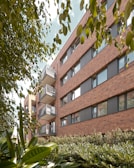 a building with balconies and plants in front of it