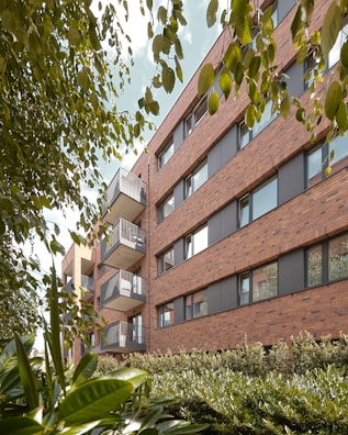 a building with balconies and plants in front of it