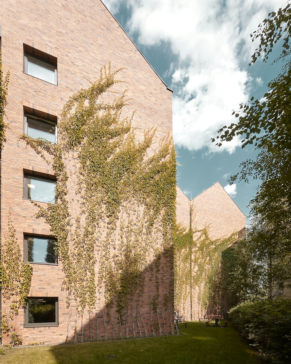 a brick building with a grass lawn