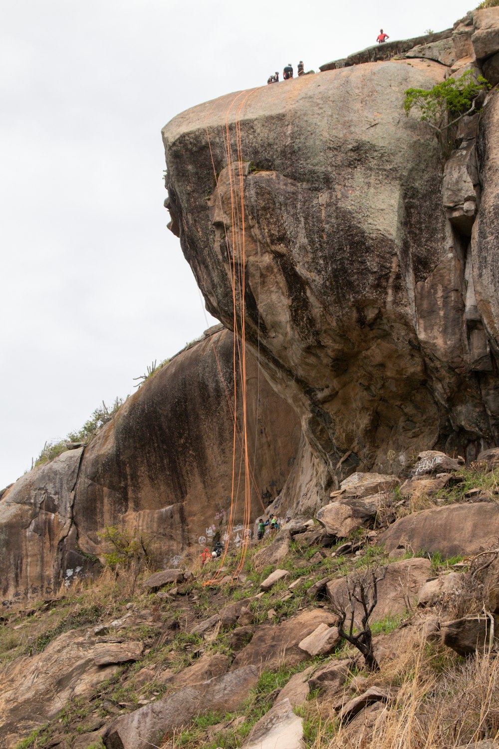 a group of people climbing a rock