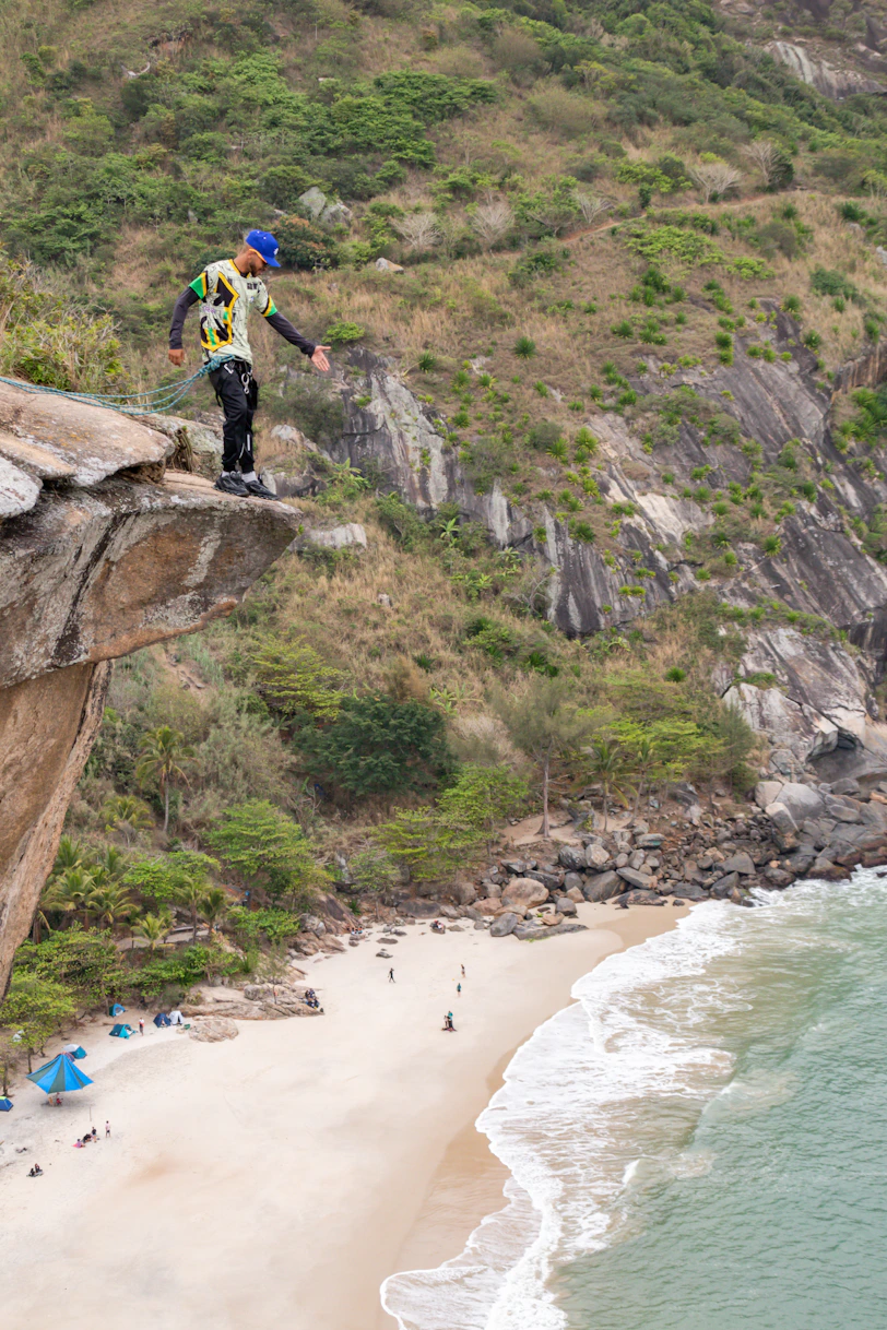 a man jumping off a cliff