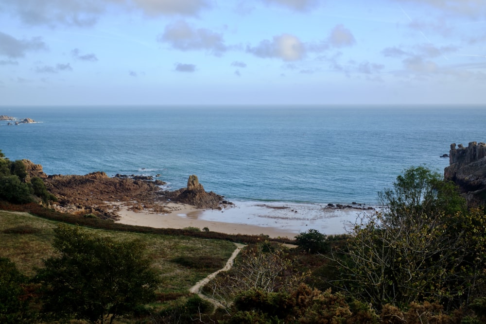 a beach with a body of water in the background