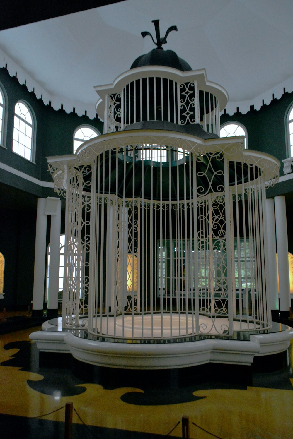 a cage with a bird on top