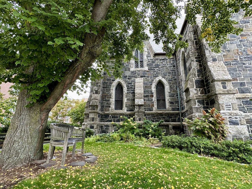 a bench sits in front of a stone building