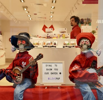 a couple of people in clothing holding guitars in a store