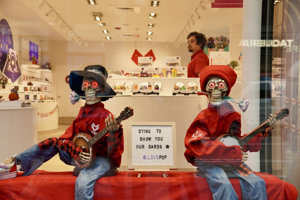 a couple of people in clothing holding guitars in a store