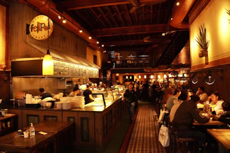 a group of people sit at a bar