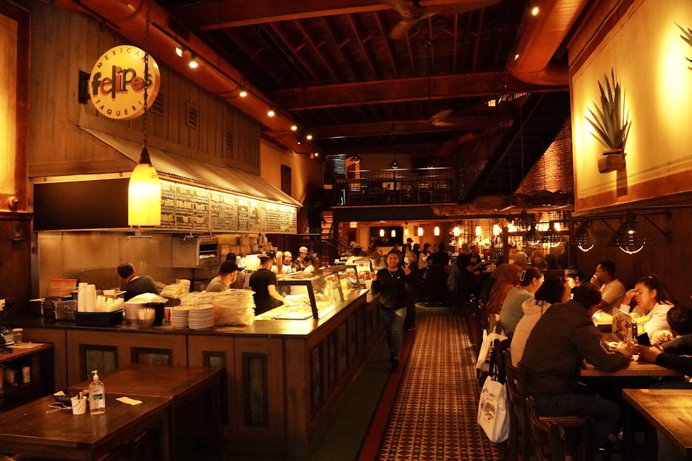 a group of people sit at a bar