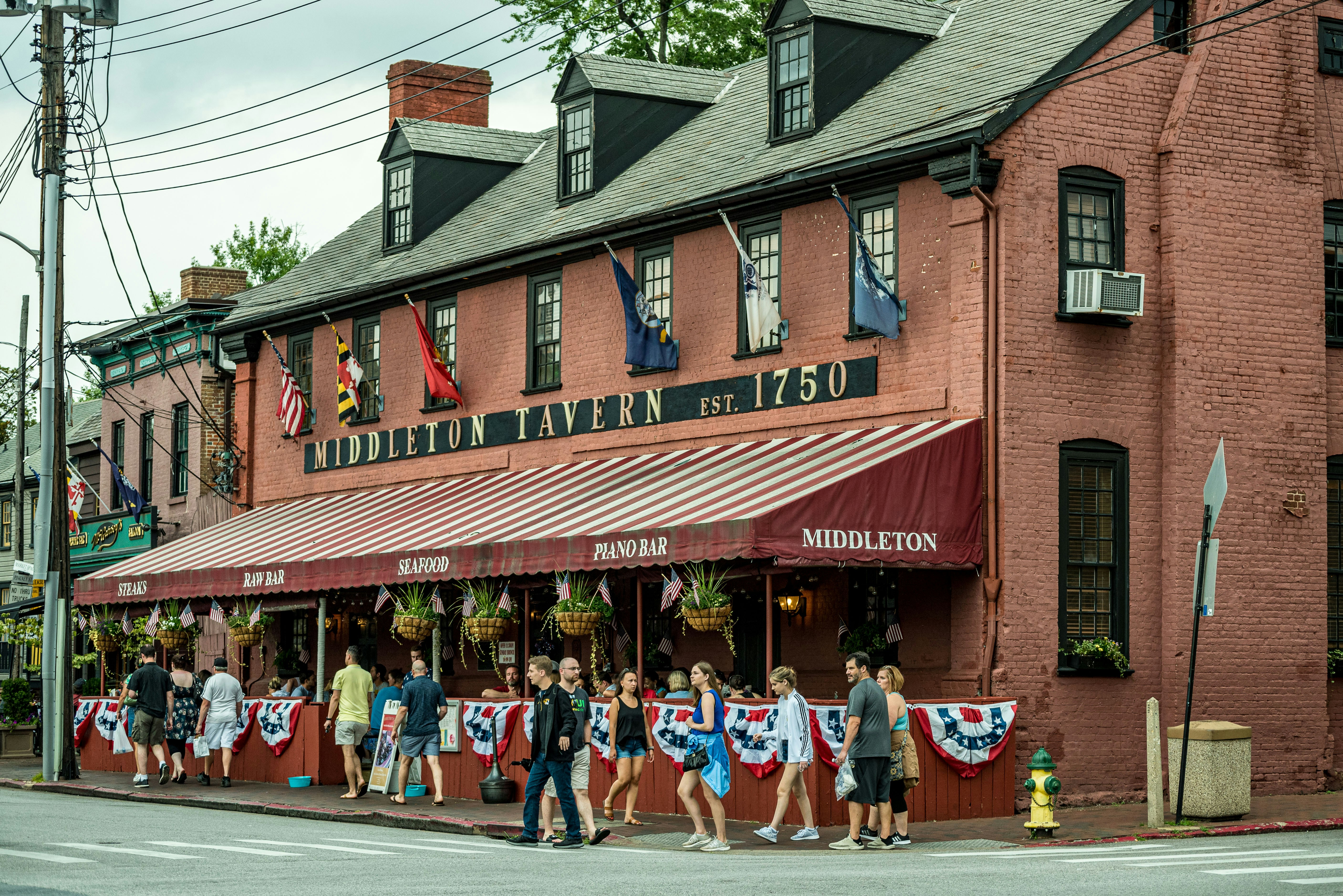 a group of people stand outside a restaurant