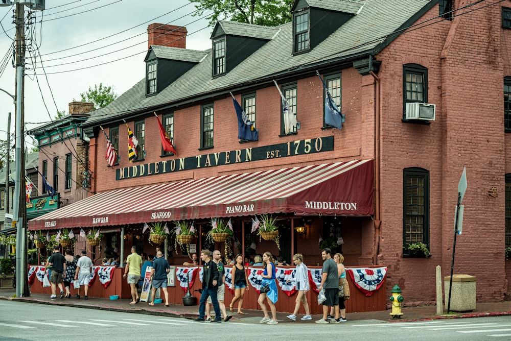 a group of people stand outside a restaurant