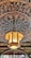 A detailed wooden carving decorates the ceiling with intricate floral patterns. Hanging from the center is an ornate lantern with a warm glow, made of wood and frosted glass, adding charm to the setting.