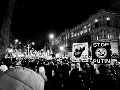 a crowd of people holding signs