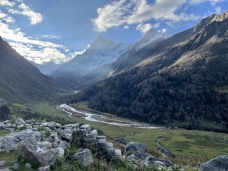 a river running through a valley between mountains
