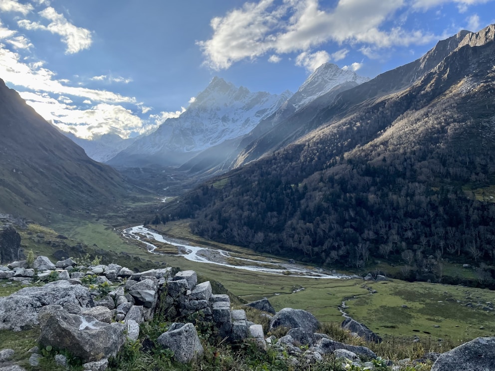 a river running through a valley between mountains