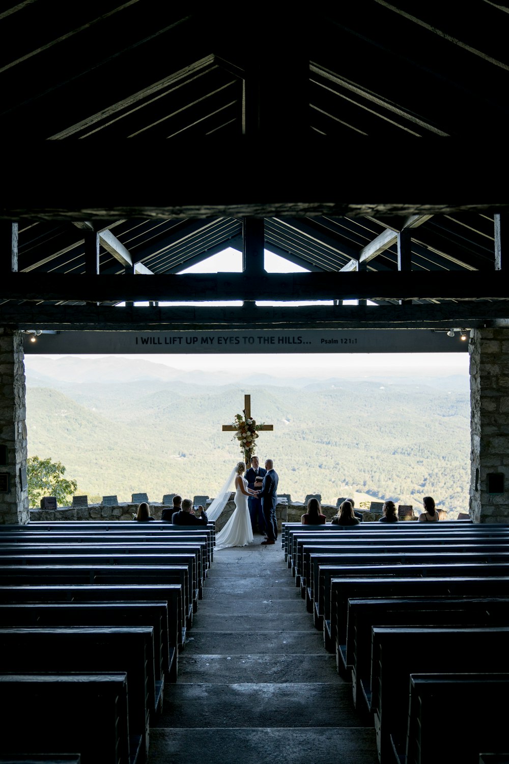 a bride and groom walking down the aisle