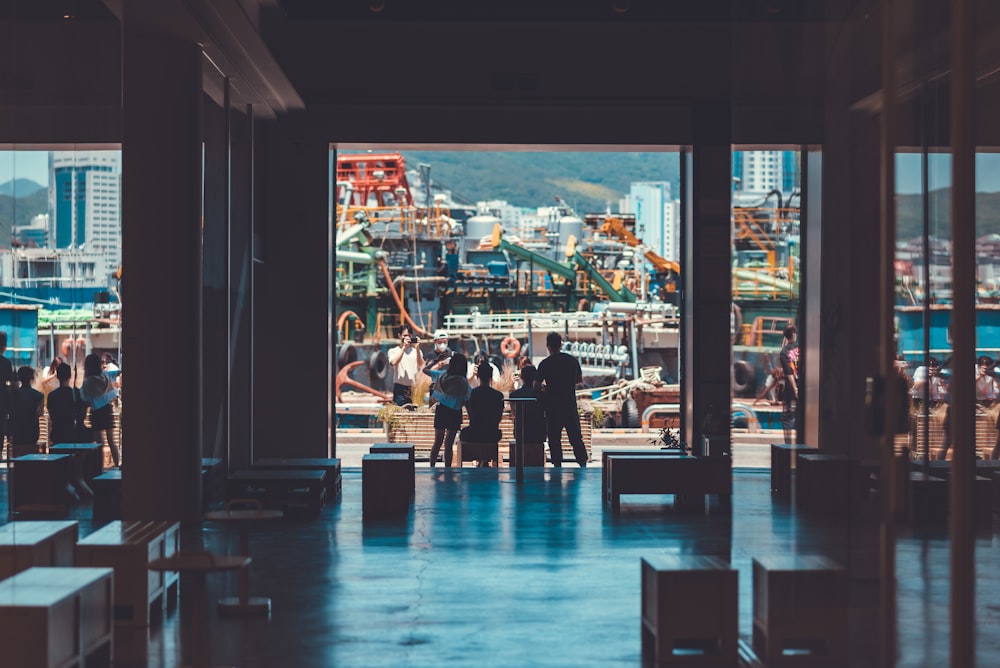 a group of people in a room with a large window